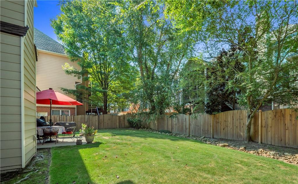 453 Hunter Street Northwest Norcross, GA 30071 - Photo 20 of 36 a view of a backyard with table and chairs and a small cabin