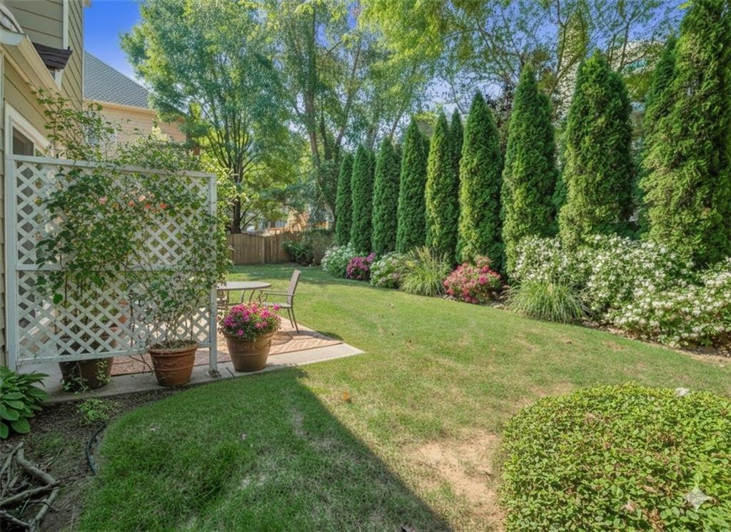 453 Hunter Street Northwest Norcross, GA 30071 - Photo 23 of 36 a view of a garden with potted plants and large trees