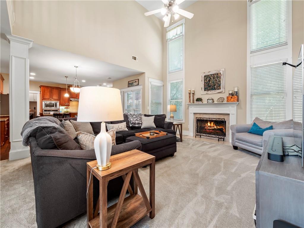 453 Hunter Street Northwest Norcross, GA 30071 - Photo 7 of 36 a living room with furniture a fireplace and a chandelier