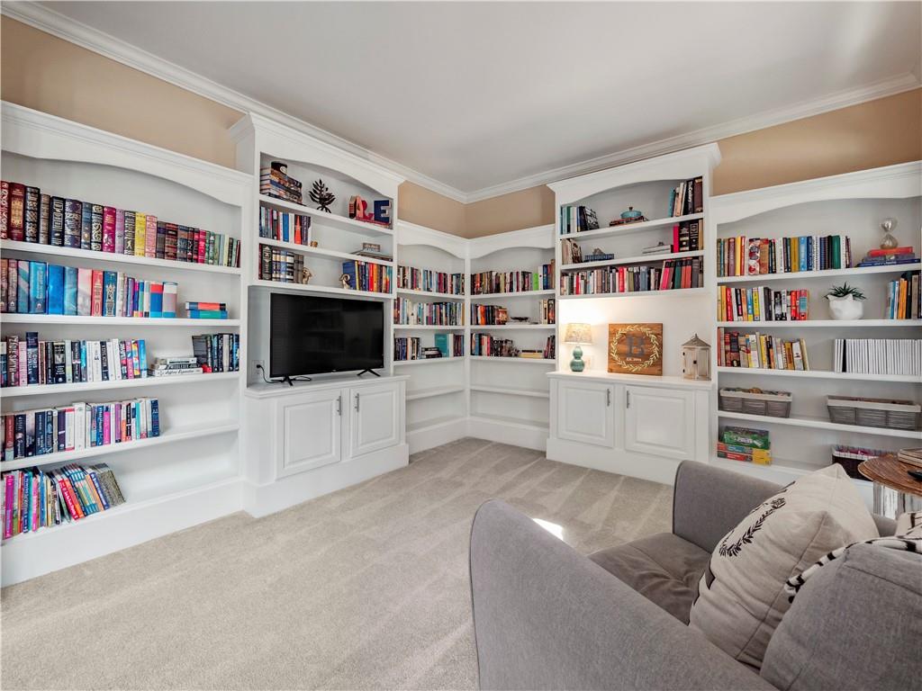 453 Hunter Street Northwest Norcross, GA 30071 - Photo 9 of 36 a living room with furniture and a book shelf