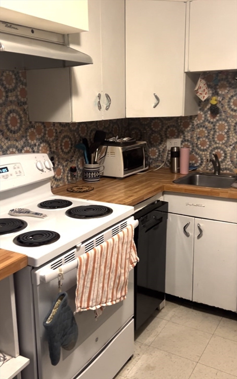 60 Parkman Street, Unit A1 Brookline, MA 02446 - Photo 2 of 6 a kitchen with stainless steel appliances granite countertop a sink and a stove