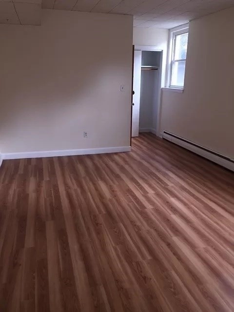 60 Parkman Street, Unit A1 Brookline, MA 02446 - Photo 4 of 6 a view of an empty room and wooden floor
