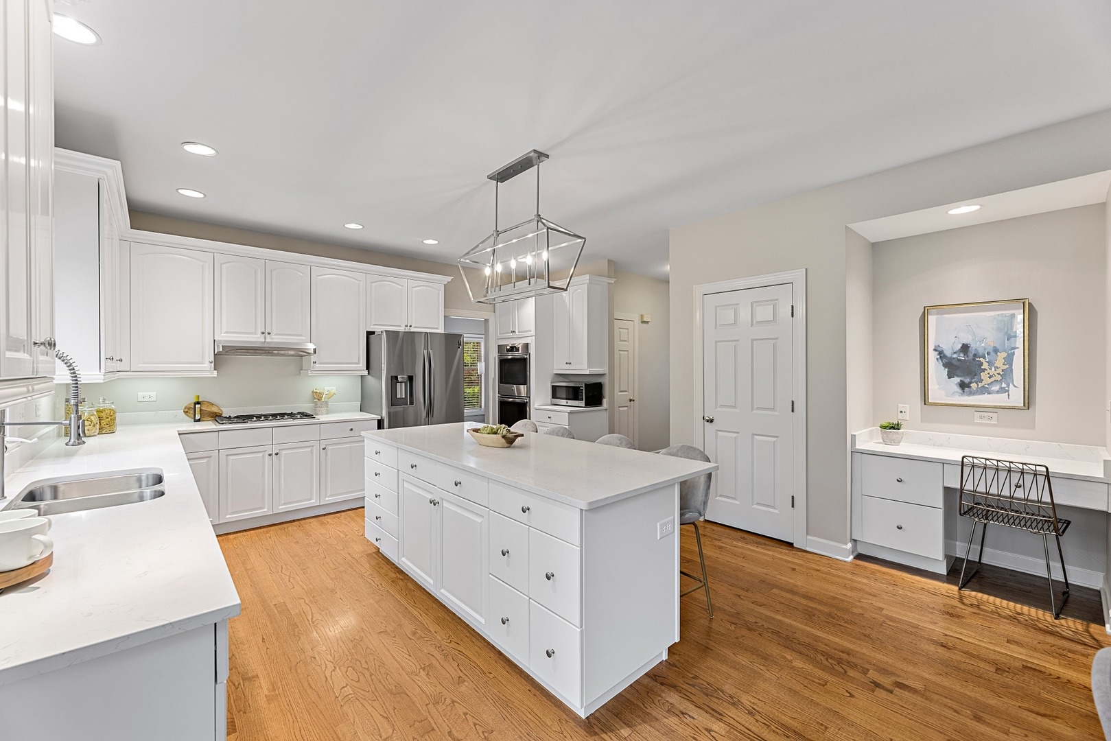 950 Shermer Road Northbrook, IL 60062 - Photo 10 of 32 a large white kitchen with kitchen island a sink a stove a dining table and chairs