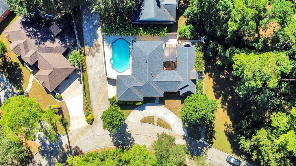 an aerial view of a house with yard swimming pool and outdoor seating