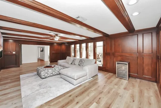 a spacious bedroom with a large bed and a chandelier