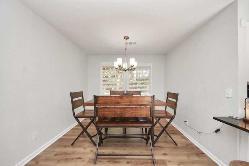 155 Springs Edge Drive Conroe, TX 77356 - Photo 12 of 49 a view of a dining room with furniture and chandelier