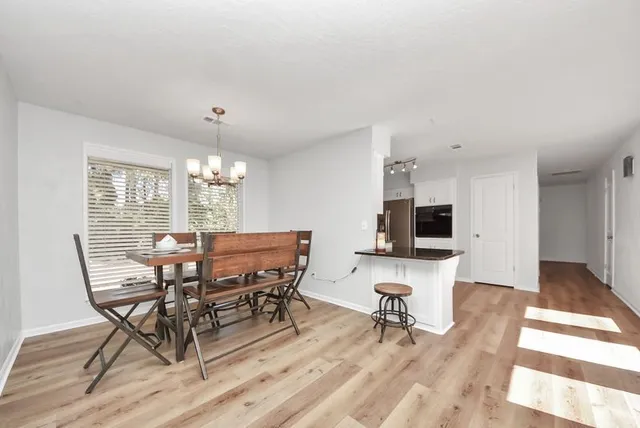 a view of a dining room with furniture and a flat screen tv