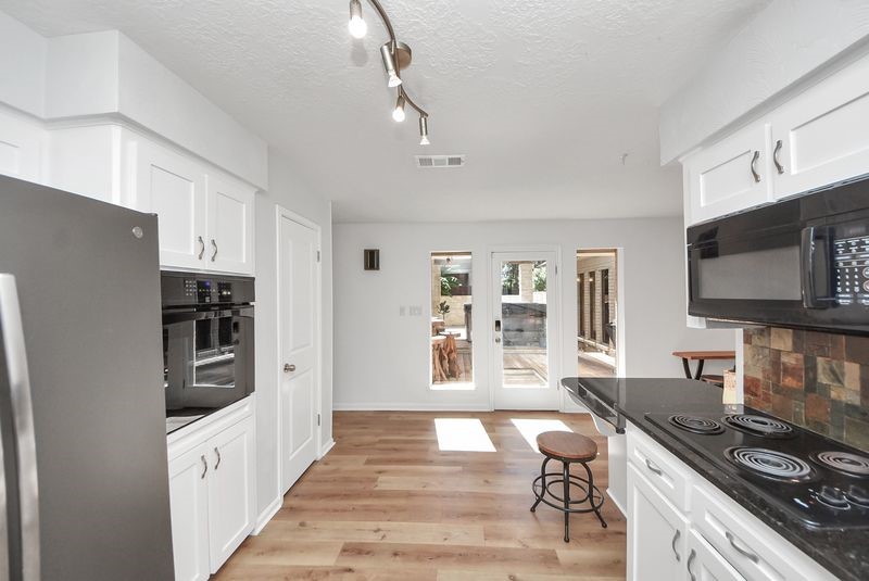 155 Springs Edge Drive Conroe, TX 77356 - Photo 18 of 49 a kitchen with stainless steel appliances a stove a sink and a refrigerator