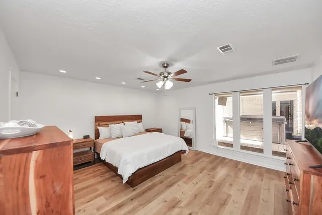 a bedroom with a bed and a large window with outer view