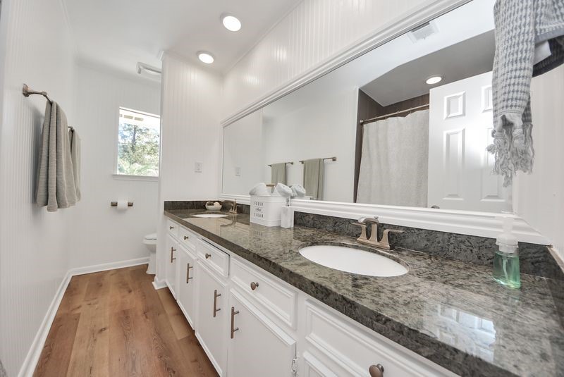 155 Springs Edge Drive Conroe, TX 77356 - Photo 24 of 49 a bathroom with a granite countertop double vanity sink and mirror