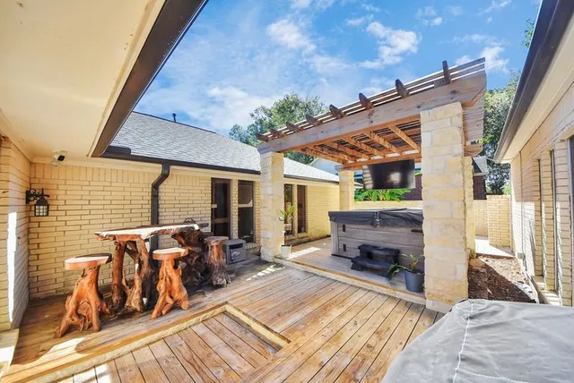 a view of an outdoor sitting area with brick walls