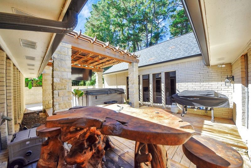 155 Springs Edge Drive Conroe, TX 77356 - Photo 39 of 49 a view of an outdoor sitting area with brick walls