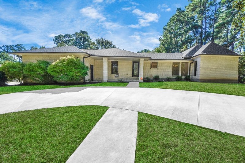 155 Springs Edge Drive Conroe, TX 77356 - Photo 49 of 49 a front view of a house with a yard and potted plants