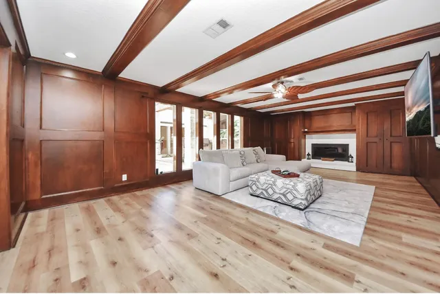 a living room with furniture fireplace and flat screen tv