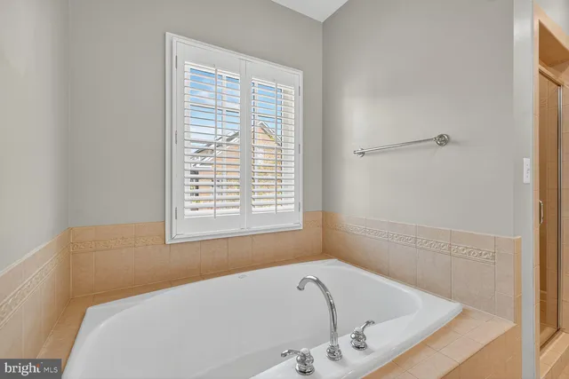 a bath tub sitting in a bathroom next to a window