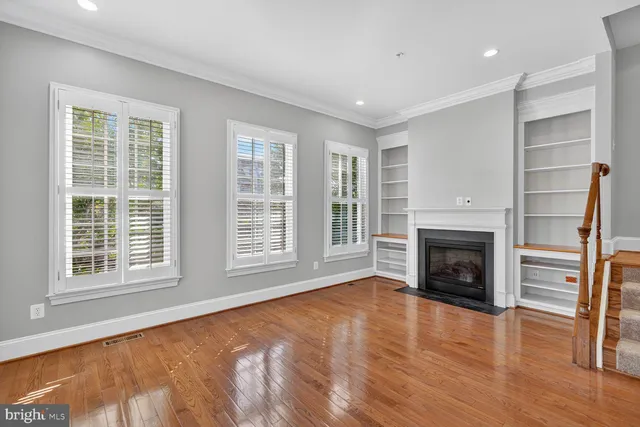 a view of an empty room with a fireplace and a window