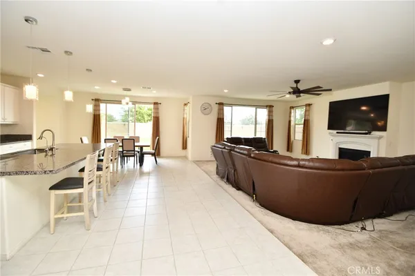 a dining area with a table chairs and a kitchen view