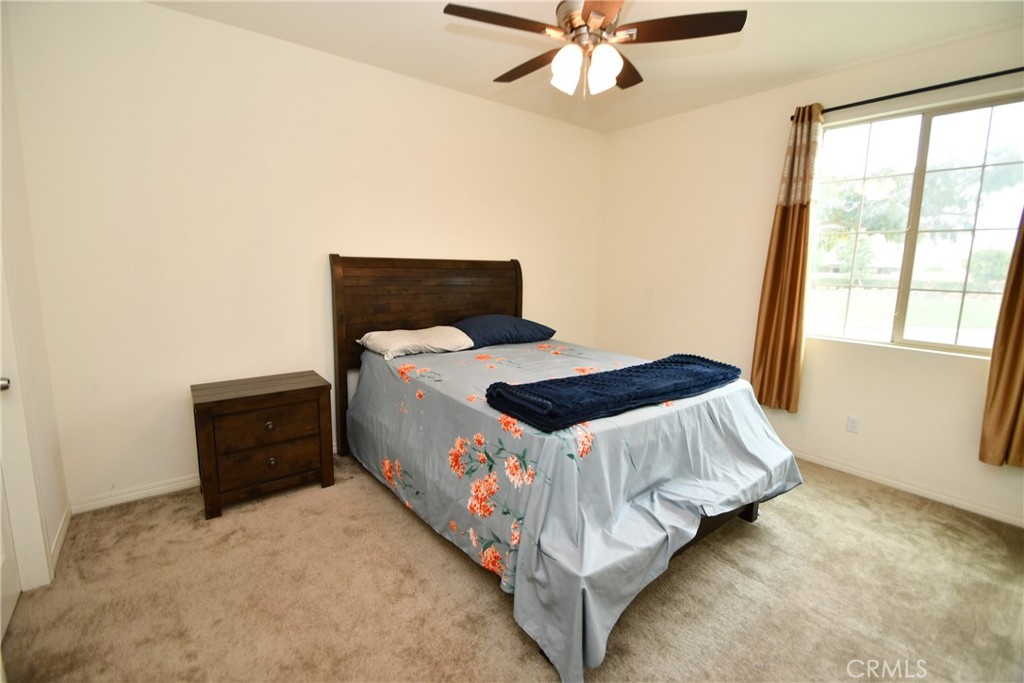 5367 Heitz Way Fontana, CA 92336 - Photo 23 of 50 a bedroom with a bed and a window