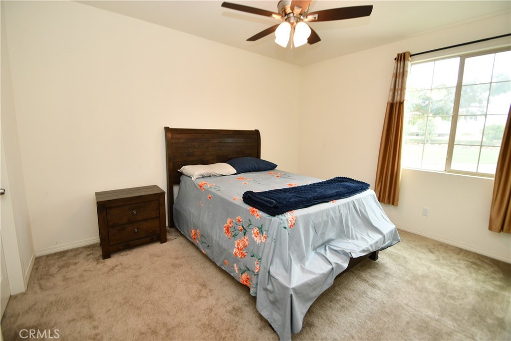 5367 Heitz Way Fontana, CA 92336 - Photo 3 of 50 a bedroom with a bed and a window