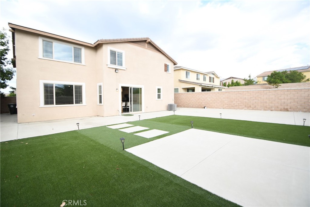5367 Heitz Way Fontana, CA 92336 - Photo 36 of 50 a front view of a house with a yard and garage