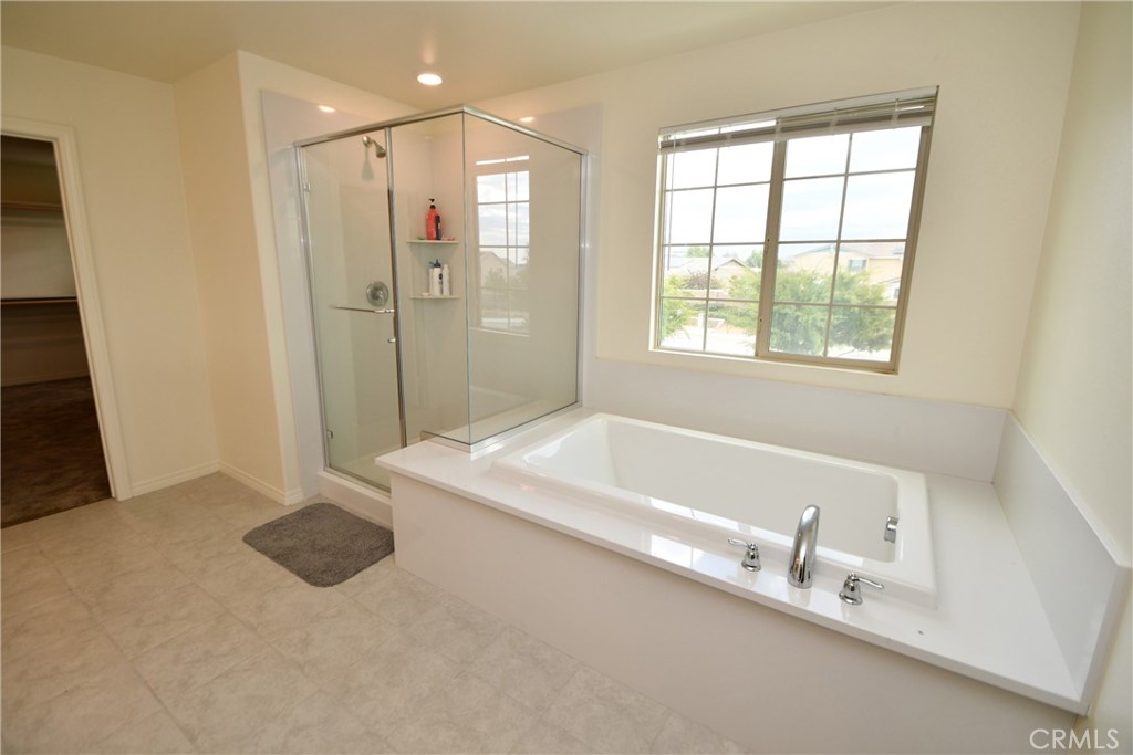 5367 Heitz Way Fontana, CA 92336 - Photo 45 of 50 a bathroom with a tub a sink and a shower