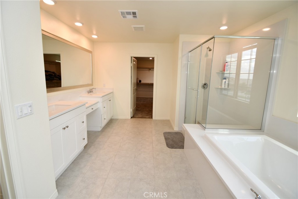 5367 Heitz Way Fontana, CA 92336 - Photo 46 of 50 a large white bathroom with a tub sink shower and mirror