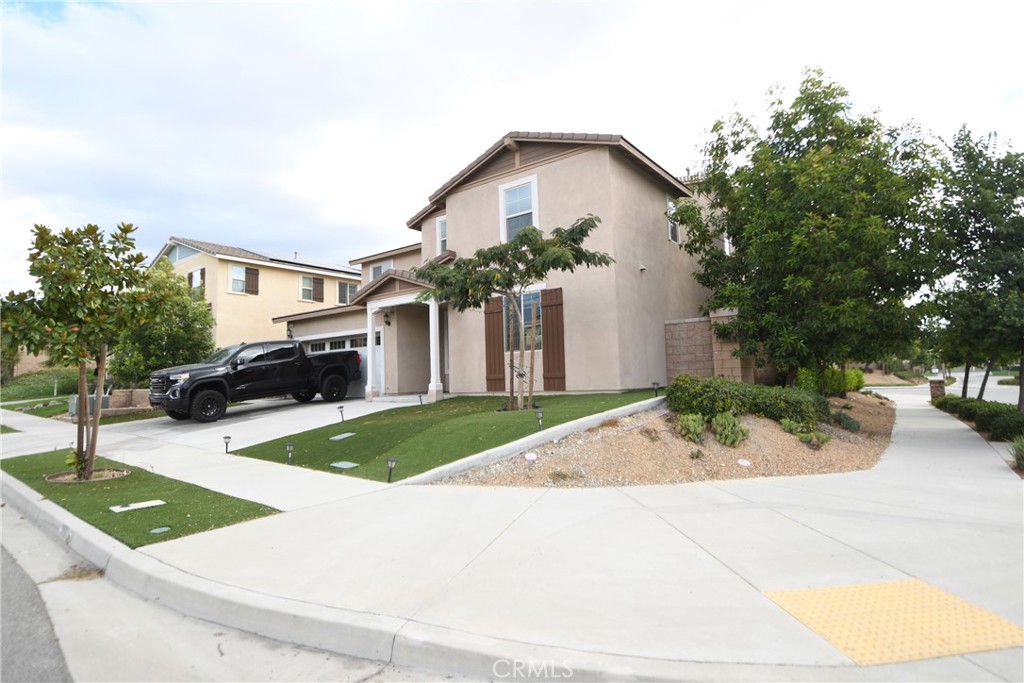 5367 Heitz Way Fontana, CA 92336 - Photo 47 of 50 a front view of a house with garden