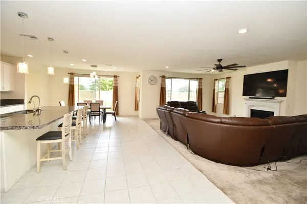 a large white kitchen with lots of counter space and furniture