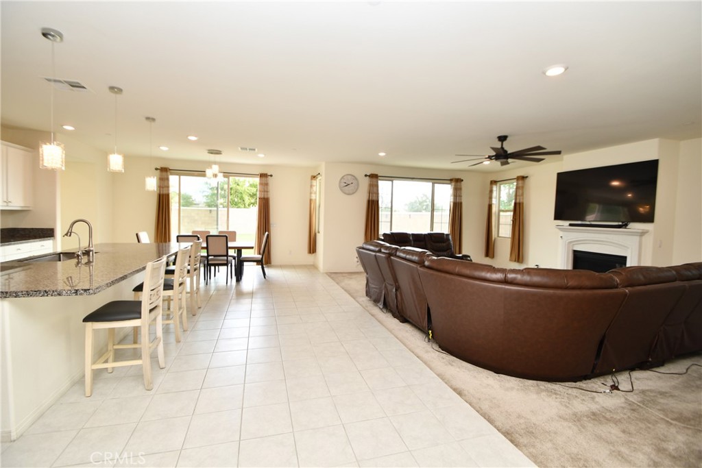 5367 Heitz Way Fontana, CA 92336 - Photo 6 of 50 a living room with furniture and a flat screen tv