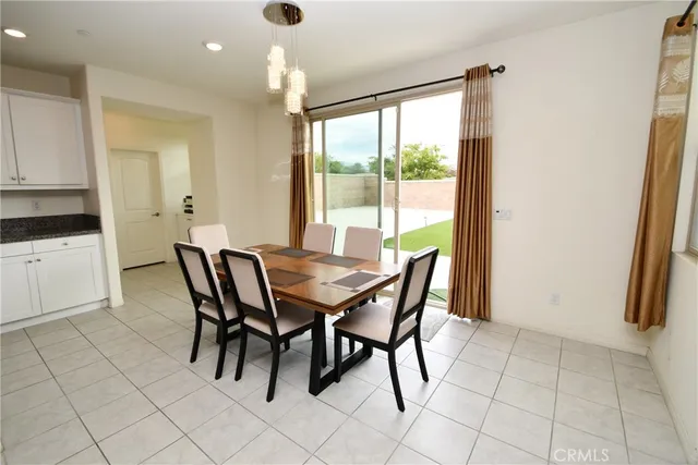 a view of a dining room with furniture and a window