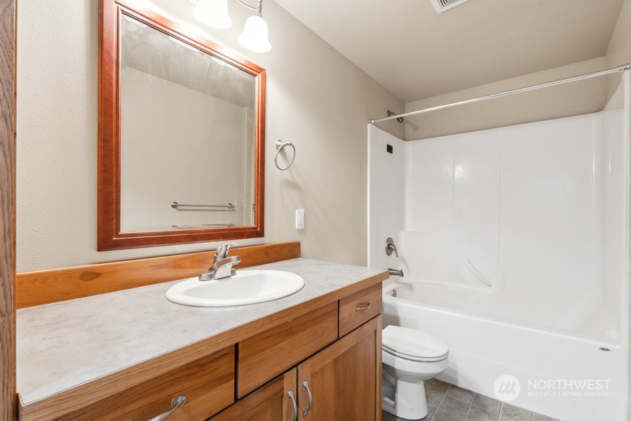 9422 Gastaeson Lane Southwest Rochester, WA 98579 - Photo 23 of 35 a bathroom with a sink a toilet and a bathtub