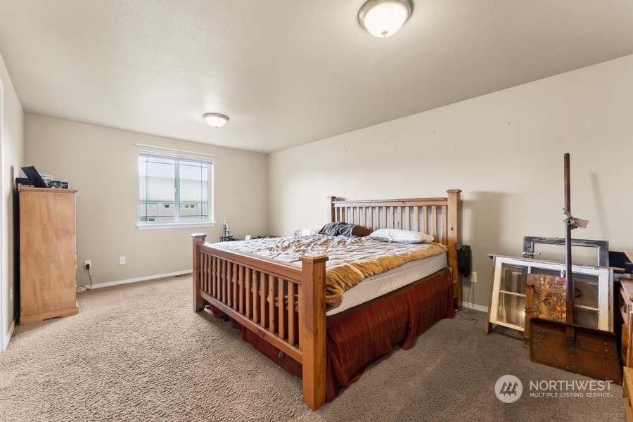 9422 Gastaeson Lane Southwest Rochester, WA 98579 - Photo 26 of 35 a bed room with a bed and a window