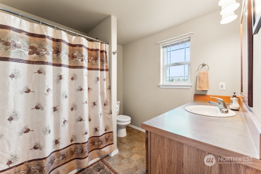 9422 Gastaeson Lane Southwest Rochester, WA 98579 - Photo 28 of 35 a bathroom with a sink toilet and shower