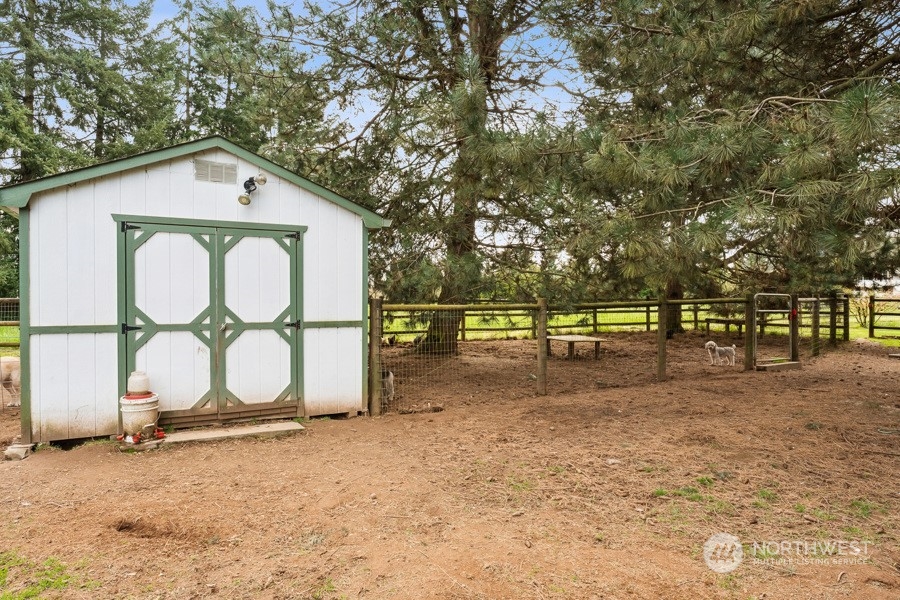 9422 Gastaeson Lane Southwest Rochester, WA 98579 - Photo 6 of 35 a view of a white house with large trees and outdoor space