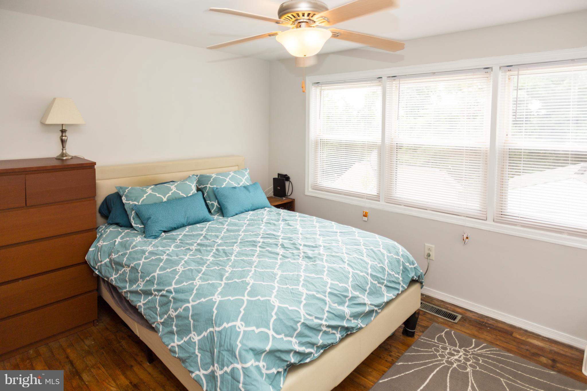 2703 Yarnall Road Halethorpe, MD 21227 - Photo 7 of 28 a bed sitting in a bedroom next to a window