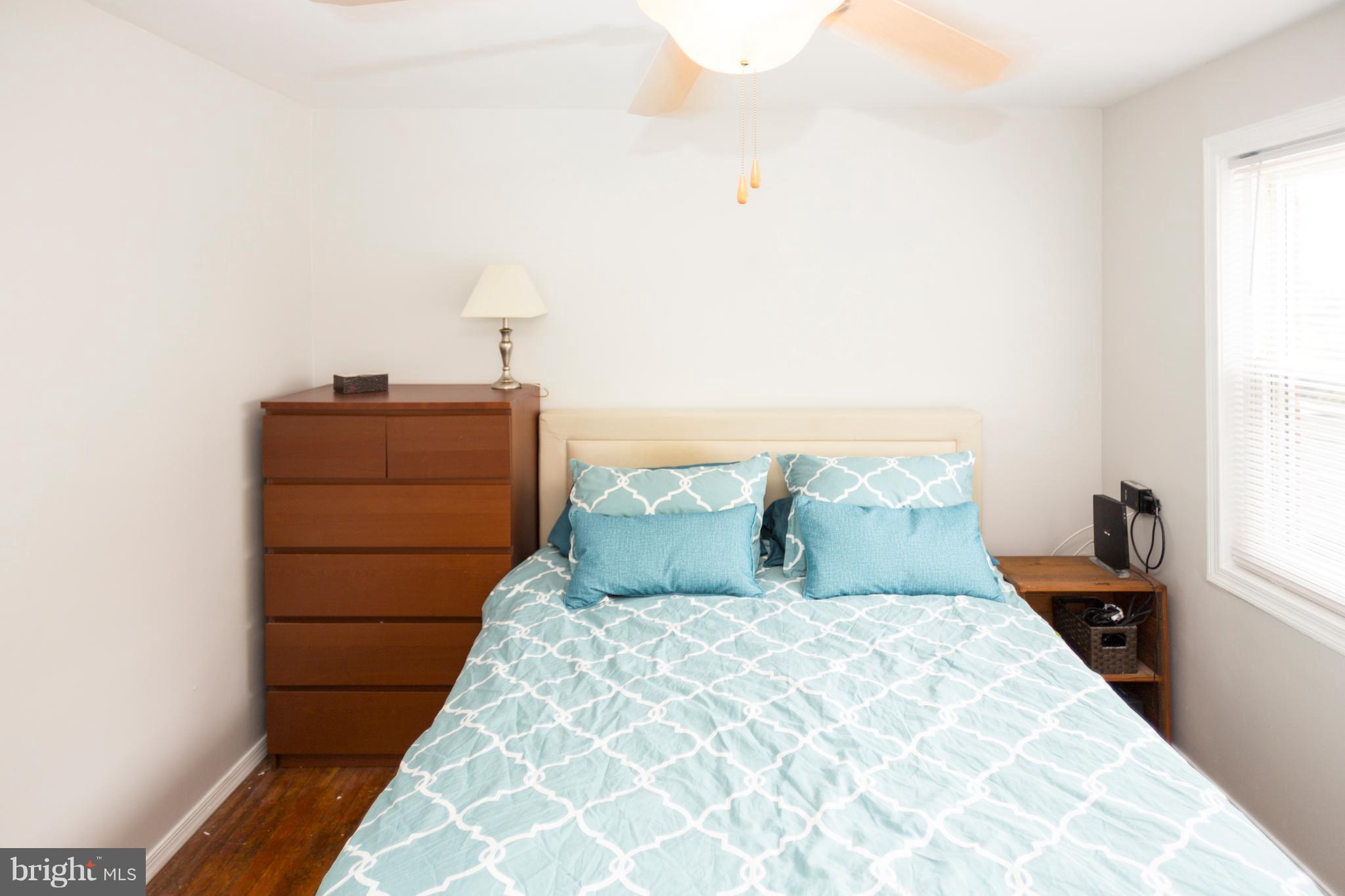2703 Yarnall Road Halethorpe, MD 21227 - Photo 9 of 28 a bedroom with a bed and a night stand