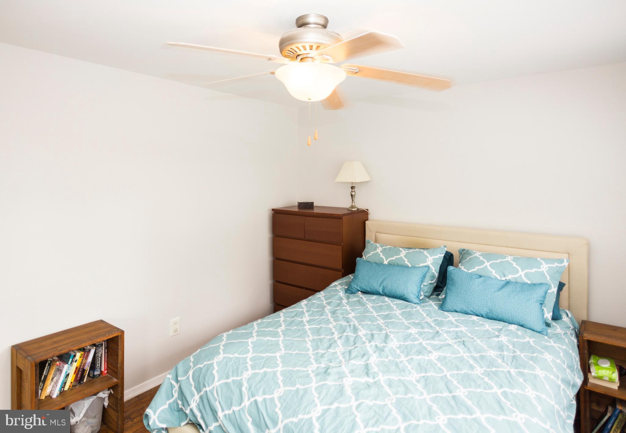 2703 Yarnall Road Halethorpe, MD 21227 - Photo 10 of 28 a bedroom with a bed and a chandelier