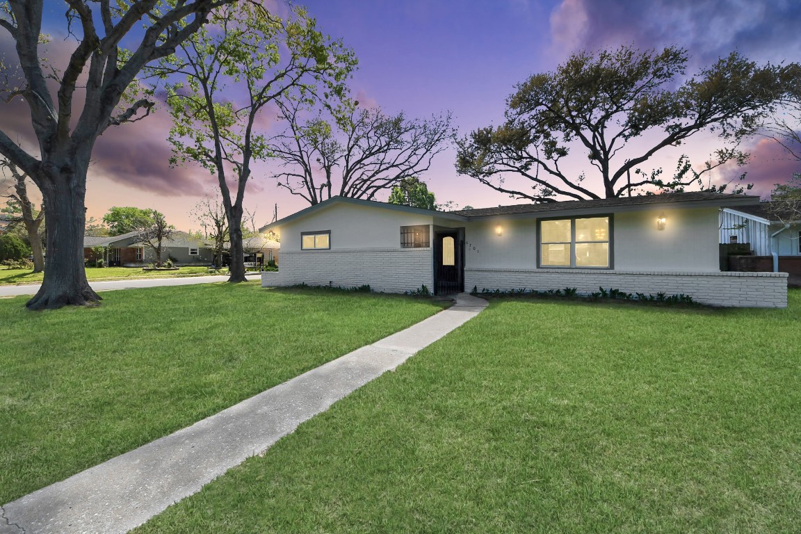 6701 Neff Street Houston, TX 77074 - Photo 1 of 44 Front exterior at dusk featuring inviting curb appeal, large front lawn, and mature trees.