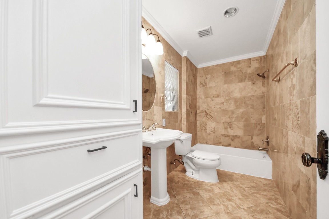 6701 Neff Street Houston, TX 77074 - Photo 22 of 44 Renovated bathroom with full tile surround, walk-in shower, and upgraded fixtures.