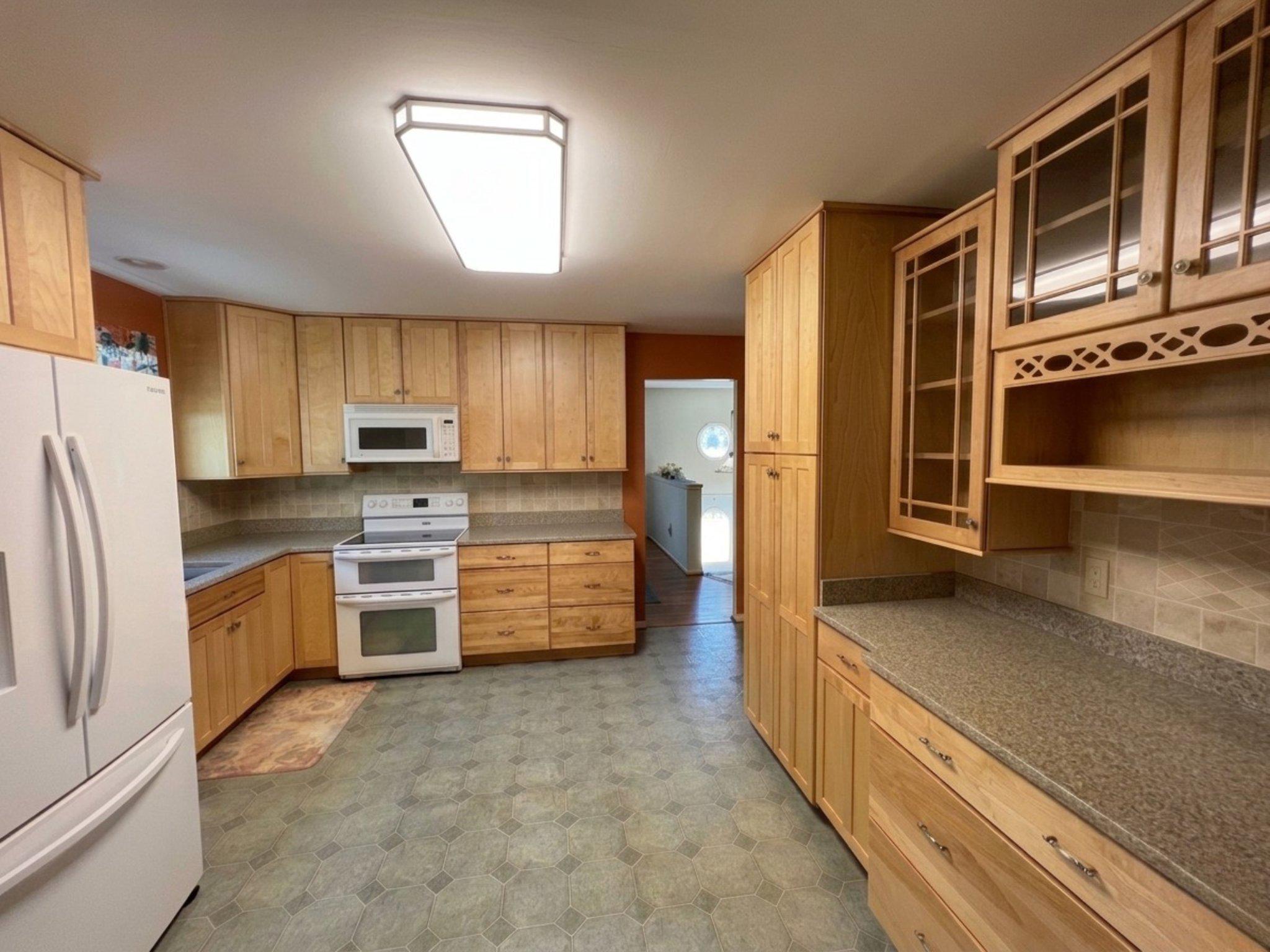 8531 Solomons Island Road North Owings, MD 20736 - Photo 5 of 12 a kitchen with stainless steel appliances a refrigerator and a stove top oven