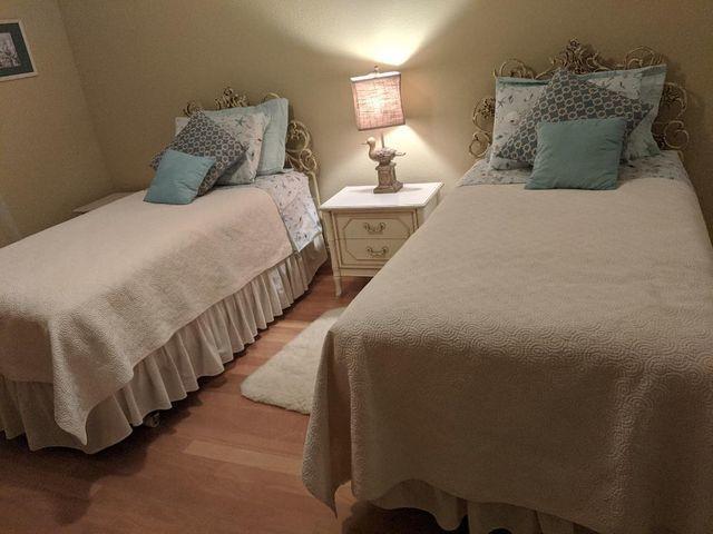 100 Cape Pointe Circle Jupiter, FL 33477 - Photo 13 of 25 a bedroom with bed and a chandelier