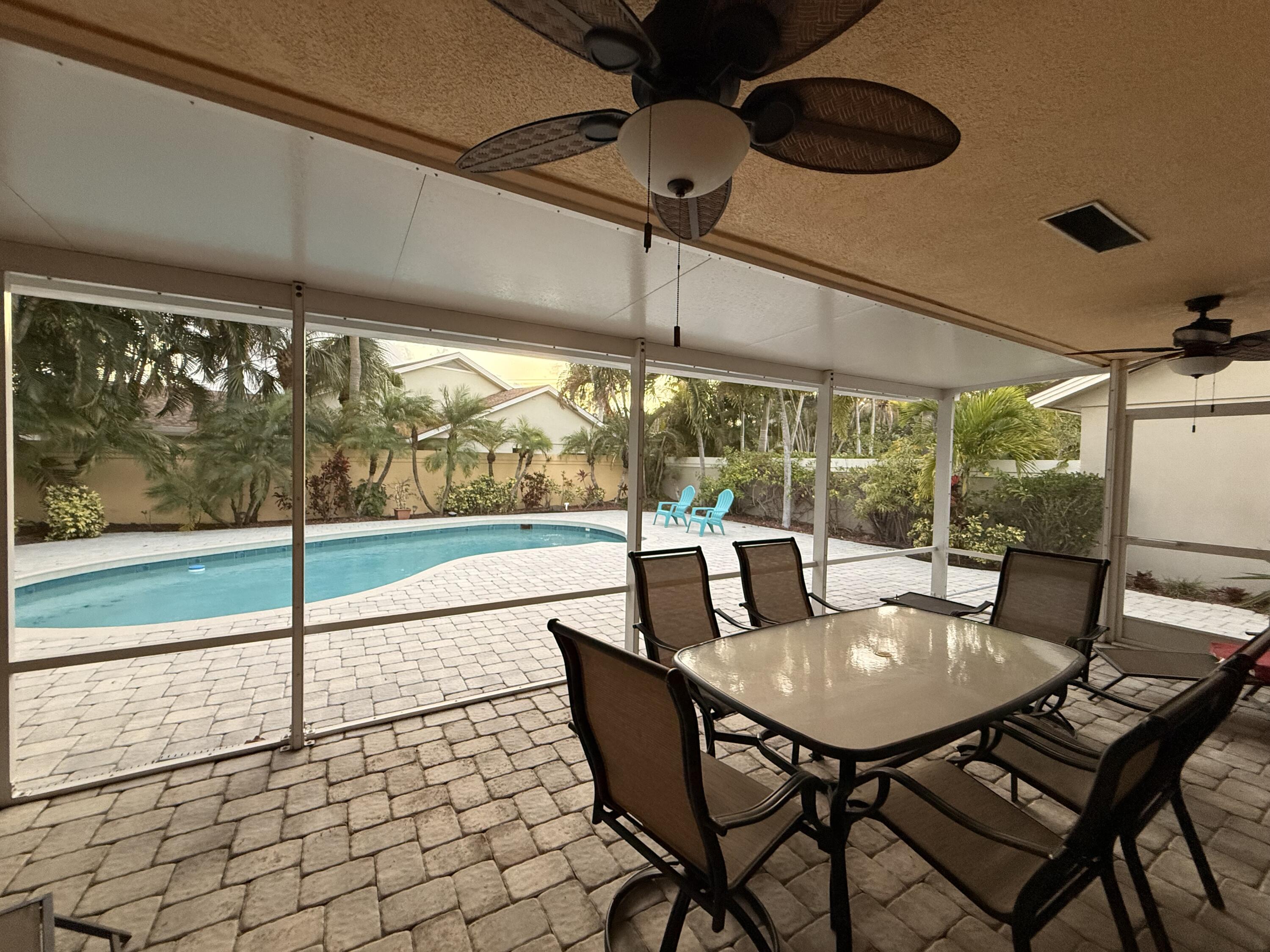 100 Cape Pointe Circle Jupiter, FL 33477 - Photo 23 of 33 a view of a patio with a table chairs and a table