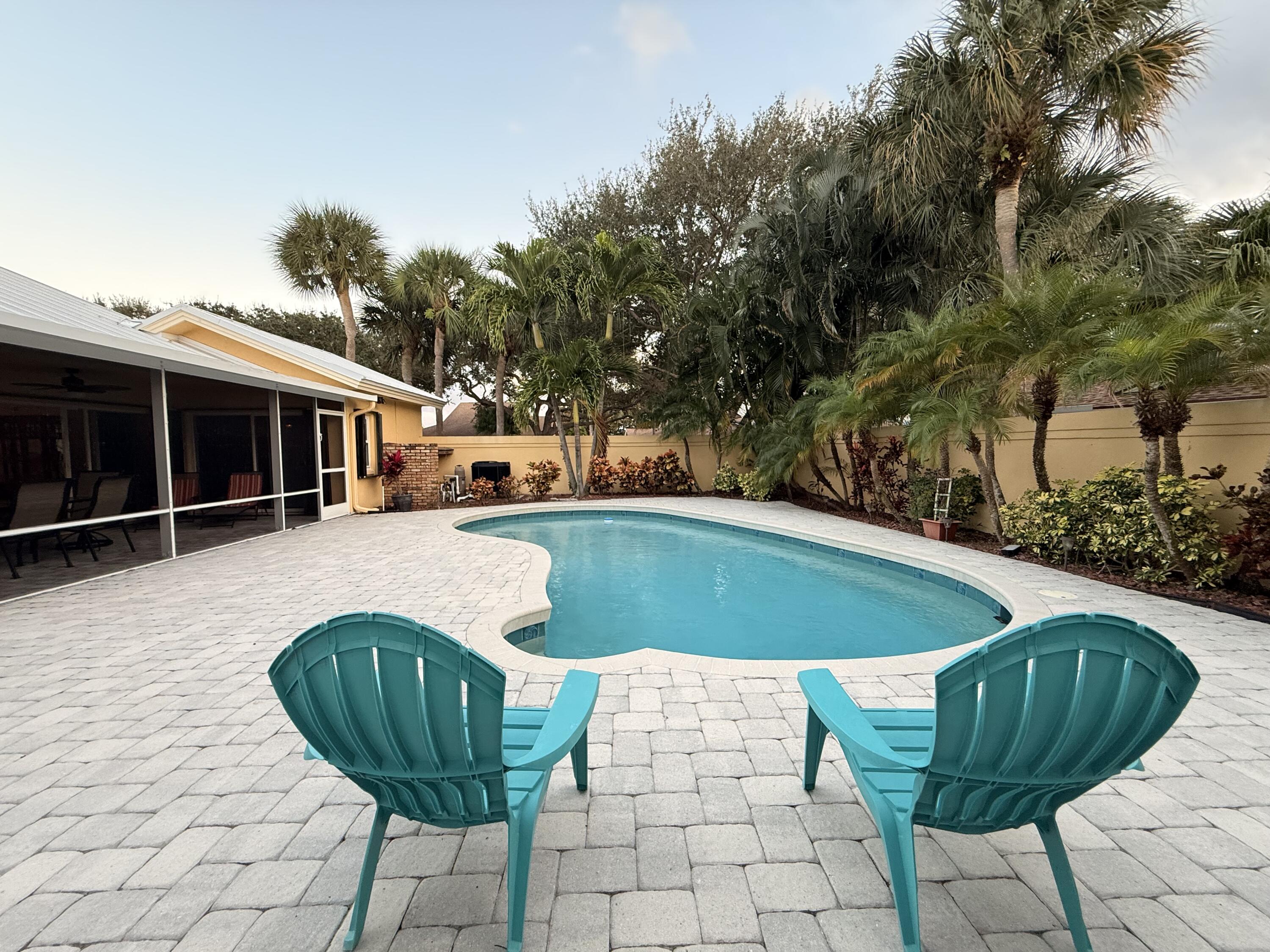 100 Cape Pointe Circle Jupiter, FL 33477 - Photo 27 of 33 a view of a swimming pool with a lounge chairs