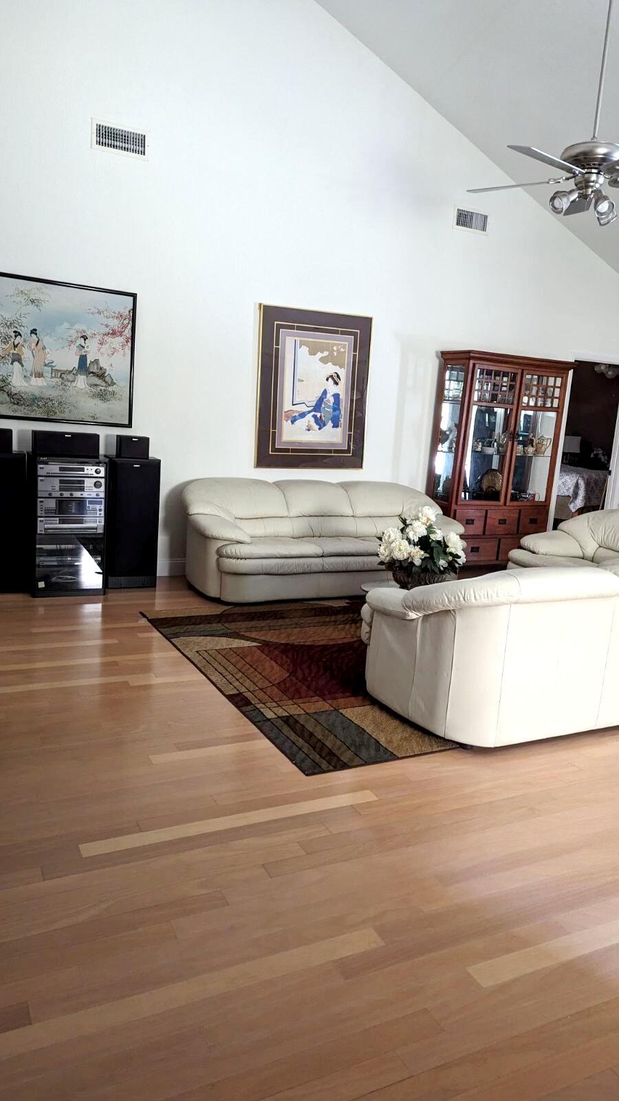 100 Cape Pointe Circle Jupiter, FL 33477 - Photo 3 of 25 a living room with furniture and a fireplace