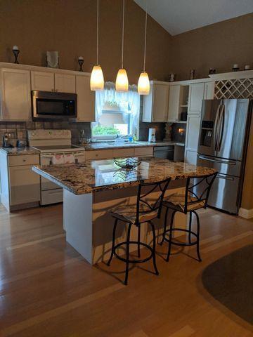 100 Cape Pointe Circle Jupiter, FL 33477 - Photo 7 of 25 a kitchen with stainless steel appliances a microwave a stove and refrigerator