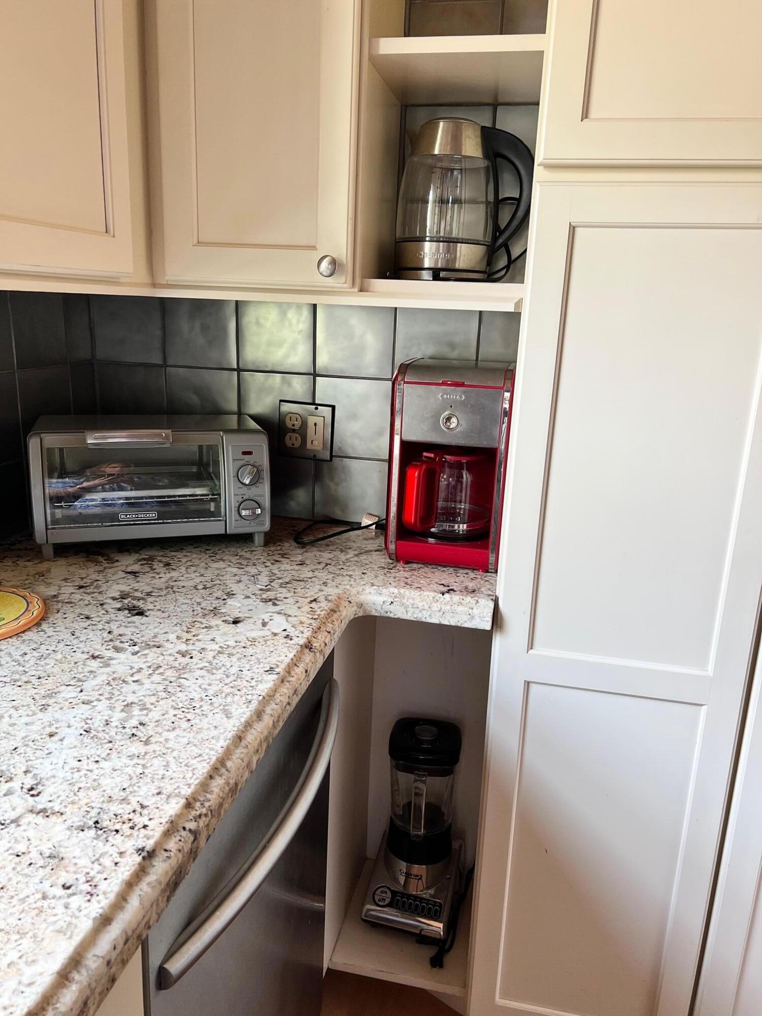 100 Cape Pointe Circle Jupiter, FL 33477 - Photo 8 of 25 a kitchen with a stove and a sink