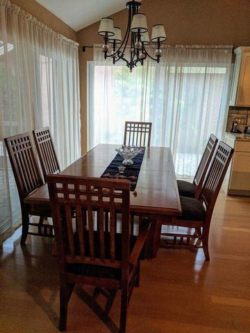 100 Cape Pointe Circle Jupiter, FL 33477 - Photo 9 of 25 a view of a dining room with furniture window and wooden floor