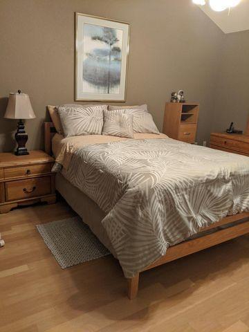 100 Cape Pointe Circle Jupiter, FL 33477 - Photo 10 of 25 a bedroom with a bed and a lamp on dresser