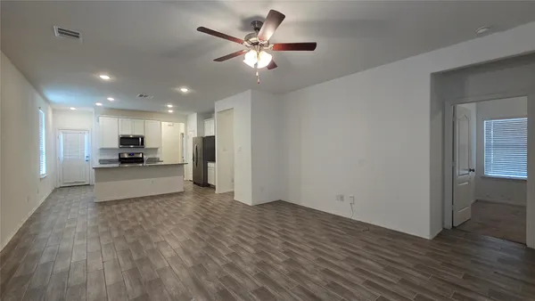 a view of kitchen with cabinets and wooden floor