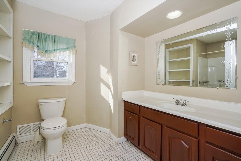 1309 Washington Street Canton, MA 02021 - Photo 13 of 35 a bathroom with a sink toilet and window